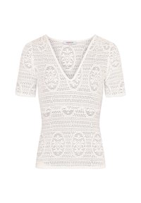 Haut blanc à manches courtes avec un décolleté en V, présentant un motif texturé de découpes complexes et de motifs circulaires tout au long.