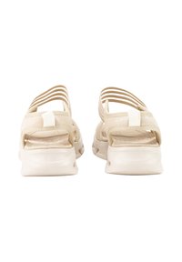 Sandalias beige con un diseño minimalista, que cuentan con correas de tela suave, una suela acolchada y detalles recortados para garantizar la transpirabilidad.