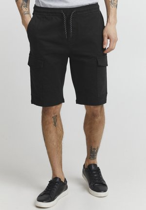 Black cargo shorts with an elastic waistband, drawstring closure, and multiple pockets. Made of soft fabric with a smooth texture.