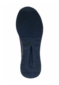 Semelle de chaussure en caoutchouc noir présentant des rainures horizontales et verticales pour une meilleure traction, avec un canal central et un détail de logo visible.