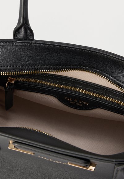 Μαύρη δερμάτινη τσάντα χειρός με χρυστό φερμουάρ, μπεζ εσωτερική επένδυση και εσωτερική τσέπη με φερμουάρ με ετικέτα «rag & bone New York».