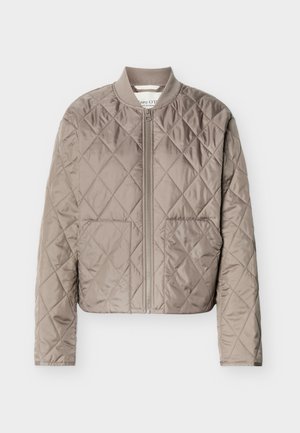 Veste matelassée marron clair avec couture en forme de losanges, fermeture éclair intégrale à l'avant, col côtelé et deux poches avant.