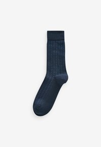 Dark blue sock with a textured pattern, featuring small raised dots and a ribbed cuff. Made of a soft, stretchy material.
