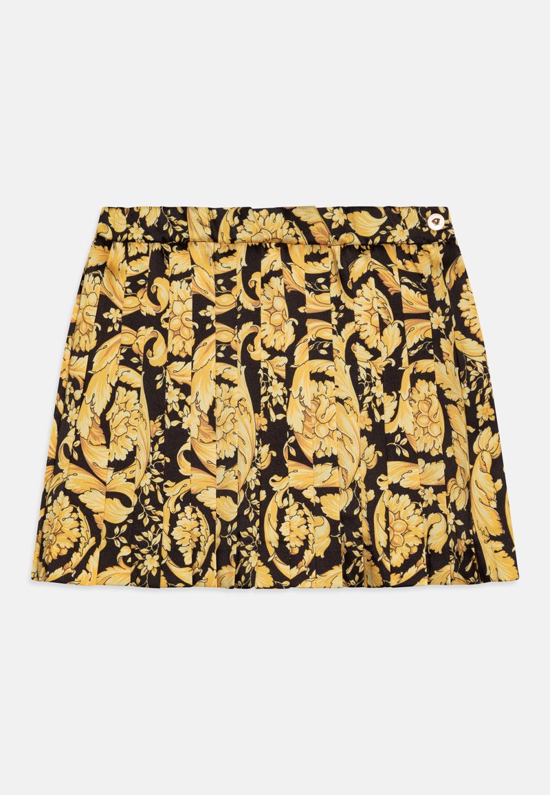 Μαύρη φούστα με κίτρινο λουλουδάτο σχέδιο, με πιέτες και ζώνη. Ένα μικρό χρυσό κουμπί προσθέτει ενδιαφέρον στη ζώνη.