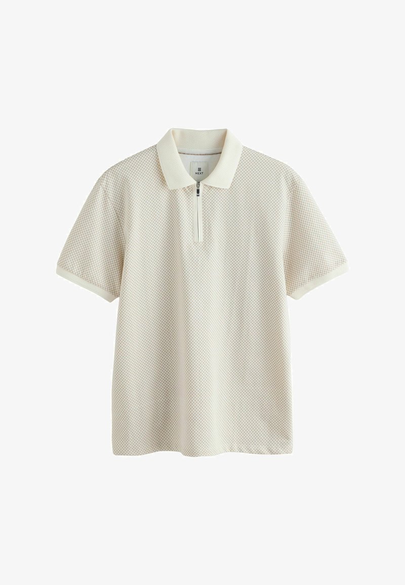 Polo à manches courtes en crème avec un motif texturé, doté d'une fermeture à glissière trois quart et d'un col côtelé de la même couleur.
