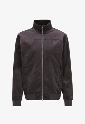 Dunkelbraune Cordjacke mit durchgehendem Frontreißverschluss, Stehkragen, zwei Fronttaschen, gerippten Bündchen und dezentem, auf der Brust gesticktem Logo.