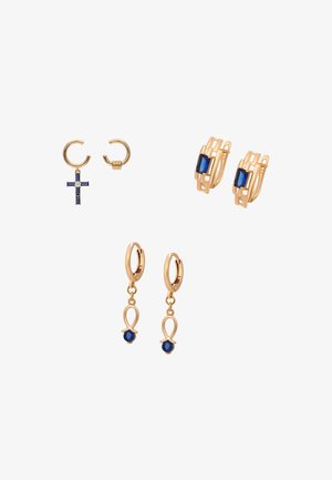 Kolme paria kultaisia korvakoruja, joissa siniset jalokivet: risti, suorakulmainen kivi ja lenkkimallit valkoisella taustalla.