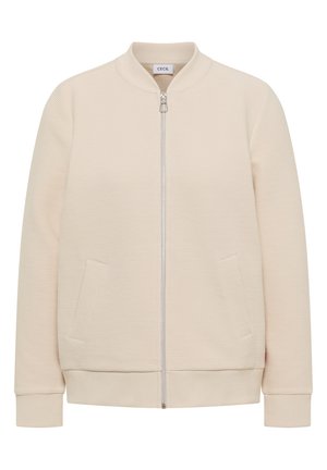 Veste bomber beige clair côtelée avec fermeture éclair avant, deux poches inclinées, poignets côtelés et petit col montant.