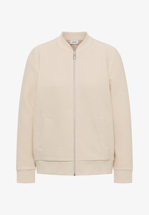 Veste bomber beige clair côtelée avec fermeture éclair avant, deux poches inclinées, poignets côtelés et petit col montant.