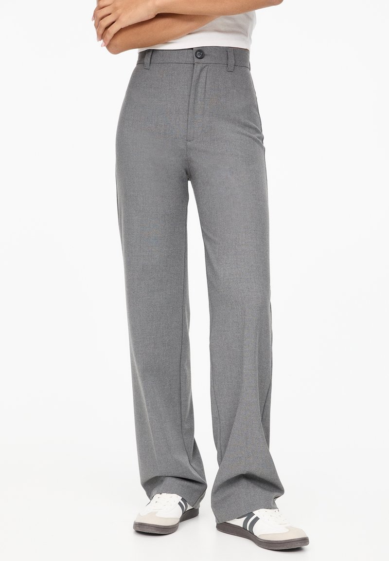 Gray, wide-leg trousers made of textured fabric with a button closure at the waist, featuring side pockets and tailored hemline.