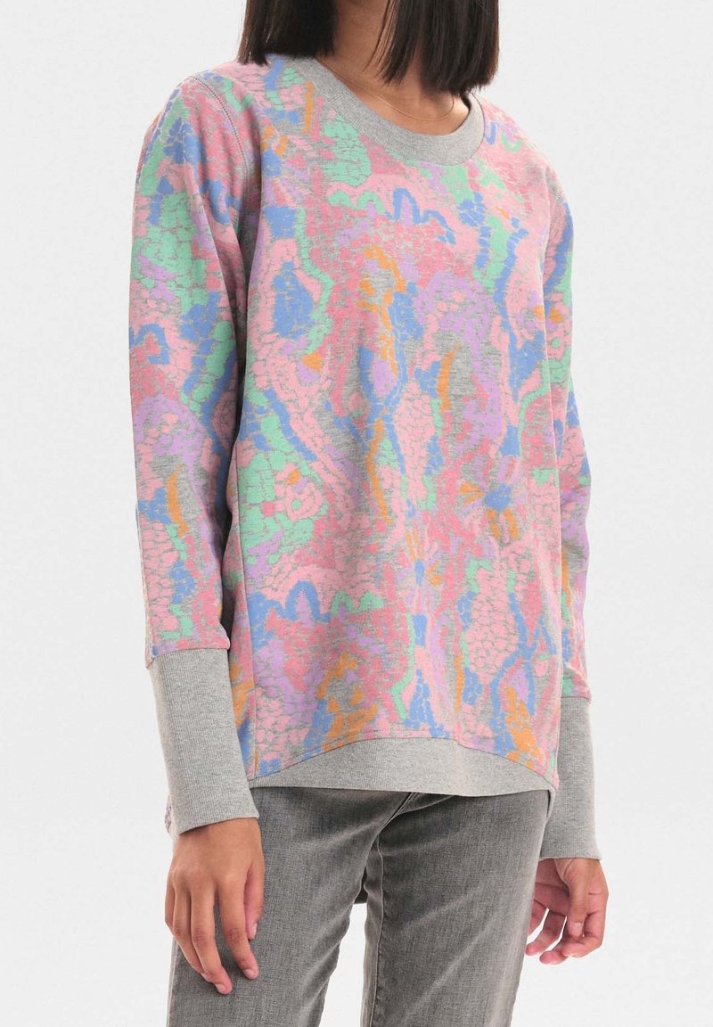 Sweat-shirt multicolore présentant un col et des poignets gris, avec un motif texturé et abstrait en rose, bleu, vert et orange. Coupe décontractée.