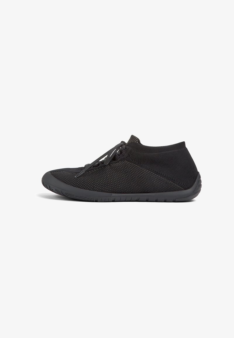 Black athletic shoes featuring a breathable mesh upper, flexible rubber sole, and flat design with lace-up closure. Textured surface detail.