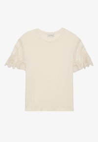 Cream-colored t-shirt with short sleeves featuring intricate beige crochet lace accents. Soft cotton fabric, round neckline, relaxed fit.