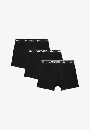Schwarze Baumwoll-Boxershorts im 3er-Pack mit einem weißen, aufgedruckten Lacoste-Logo auf dem kontrastierenden Bund. Glatte Textur, mittlere Oberschenkellänge.