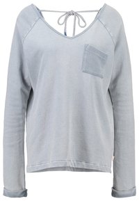 Maglietta a maniche lunghe azzurro chiaro in morbido tessuto. Design a V con chiusura a cravatta sul retro, tasca frontale e polsini arrotolati. Vestibilità casual.