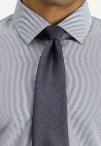 Camisa de dress a cuadros en azul marino y blanco con cuello tipo spread, combinada con una corbata texturizada en azul oscuro que presenta un patrón sutil.