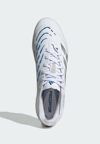 White athletic shoe with blue and gray accents, textured upper, lace closure, and "PREDATOR" branding on the insole. Streamlined design.