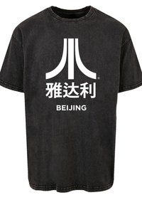 Black cotton t-shirt with a round neck, featuring a large white graphic with stylized text and a logo centered on the front.