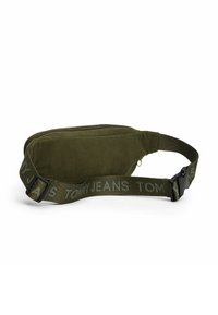 Sac banane en velours côtelé vert olive avec fermeture à glissière et sangle ajustable imprimée du logo "TOMMY JEANS" en gris.