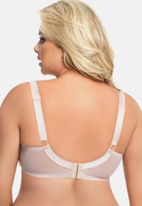 Sutien light beige cu armătură, cu bretele ajustabile și închidere la spate. Prezintă țesătură netedă și detalii din picot pe margini.