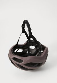 Kask rowerowy w stonowanym fioletowym odcieniu z czarnymi paskami; charakteryzuje się lekką, wentylowaną konstrukcją oraz teksturowanym wnętrzem dla wygody.