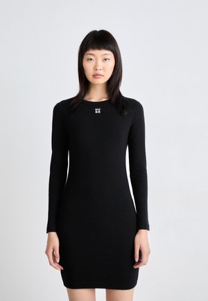 Black long-sleeve dress featuring a fitted design and a small silver logo on the chest, displayed against a neutral background.