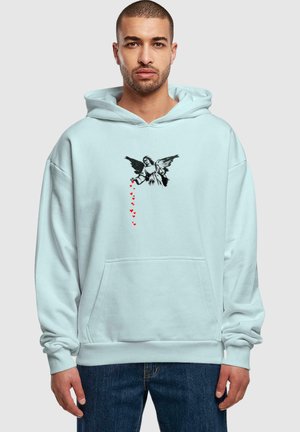 Light blue hoodie with a front pocket, featuring a black graphic of an angel and red heart accents. Cotton material, relaxed fit.