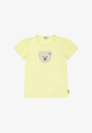 T-shirt giallo a maniche corte con scollatura rotonda e maniche a sbuffo, caratterizzato da un'applicazione a forma di faccia d'orso grigia e beige al centro.