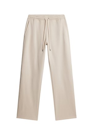 Pantalons de survêtement beige avec taille élastiquée à cordon de serrage, deux poches latérales et coupe décontractée ; fabriqués en tissu doux et lisse. Aucun motif ni logo visible.