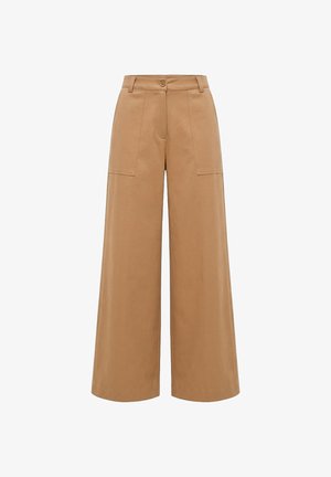 Hochgeschnittene, weit geschnittene Hosen in Hellbraun mit aufgesetzten Taschen vorne, Gürtelschlaufen, Knopfverschluss und Nahtdetails entlang der Beine.