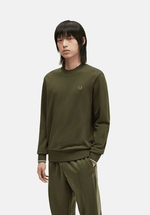 Sudadera de algodón verde con mangas largas y puños acanalados. Cuello redondeado. Pequeño logo bordado en el pecho. Combinada con pantalones a juego.
