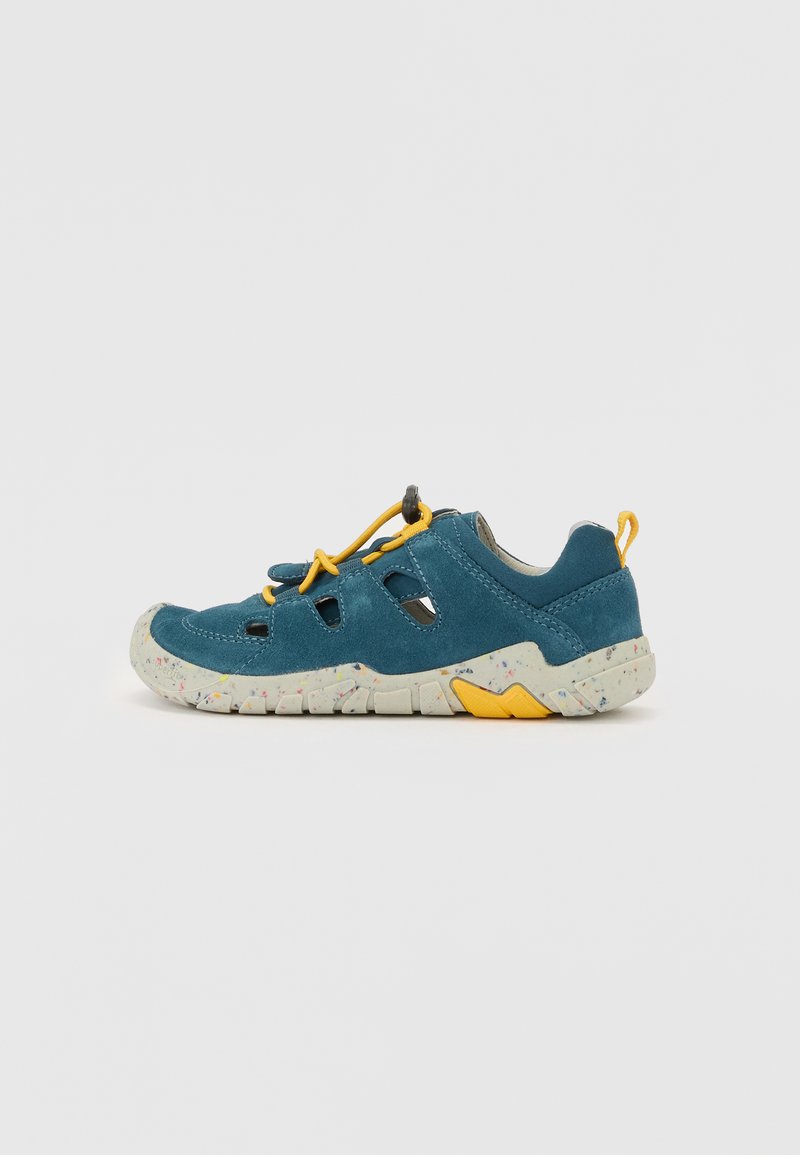 Teal suede shoe with cutouts, yellow accents, and a speckled sole. Features a molded toe cap and elastic laces for a secure fit.