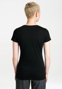 Black short-sleeve T-shirt made of smooth fabric, featuring a round neckline and a fitted silhouette, displayed from the back.