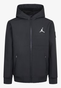 Veste noire à capuche avec zip frontal, poches latérales et logo Jordan blanc sur la poitrine. Fabriquée en tissu lisse et flexible.