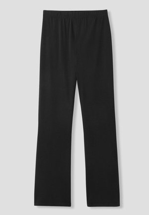 Leggings noirs en tissu doux, dotés d'une taille élastique et d'une coupe droite. Pas de motifs ou d'accents distincts.