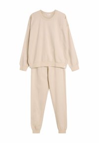 Beżowa, bawełniana bluza i dopasowane dresy. Posiada elastyczne mankiety, okrągły dekolt i luźny krój. Gładka tekstura, minimalistyczny design.