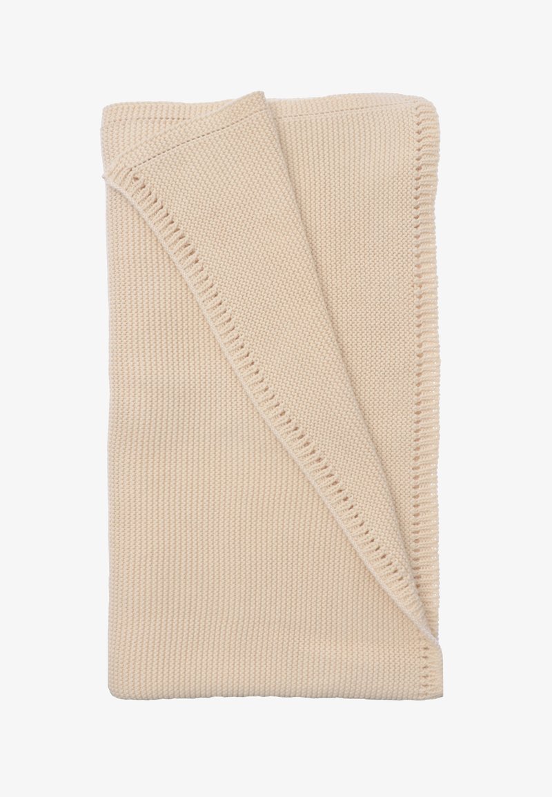 Knitted beige blanket folded diagonally, featuring a textured pattern and a neat stitched edge. Soft and warm fabric appearance.