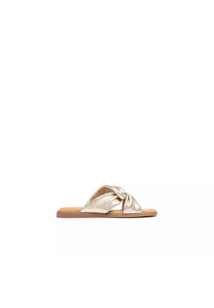 Flat sandal with metallic gold twisted strap and tan sole, designed for casual wear.