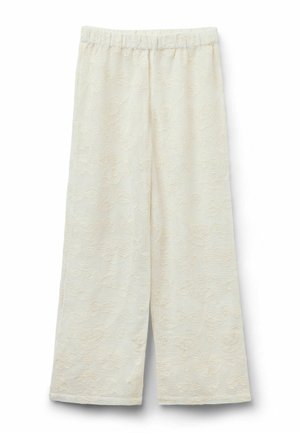Roomkleurige wijde broek met elastische tailleband, met een subtiel bloemmotief in reliëf over de hele stof.