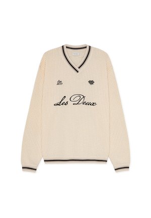 Pulover crem cu textură de vafe, cu decolteu în V negru și dantelă în dungi la manșete și tiv. Include broderia "Les Deux" și logo-ul.