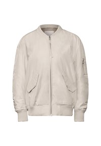 Beige bomber-tekki, jossa on etuvetoketju, ribbaatut hihansuut ja kaksi etutaskua. Materiaali on sileä ja pehmeä. Sisältää huomaamattoman hihapocketin.
