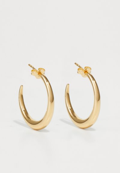 Gold-tone metal hoop earrings with a curved, elongated design and smooth surface; feature a secure post-back closure.