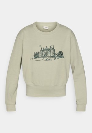 Lichtgroene sweatshirt gemaakt van zacht materiaal, met een cropped ontwerp en een ronde hals. Het heeft een ingewikkelde blauwe illustratie van een gebouw.