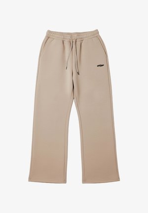 Pantaloni della tuta beige realizzati in tessuto liscio, con vita con coulisse, tasche laterali e un piccolo logo scuro vicino all'anca sinistra.