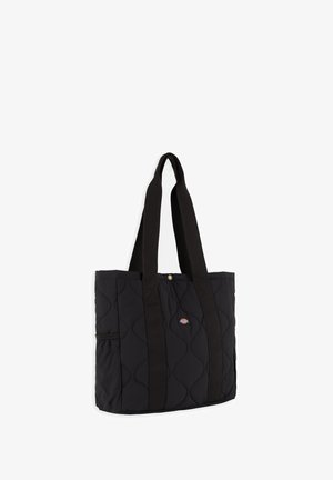 Sac cabas matelassé noir avec longues anses, petite étiquette logo sur le devant et poche élastique sur le côté.