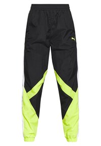 Black track pants with neon yellow and white angular accents, elastic waistband, cuffs, and a small Puma logo on the right thigh.