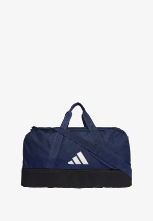 Bolsa de lona navy con base negra, que presenta un logo blanco, dos asas y una correa de hombro ajustable. Fabricada con un tejido duradero.