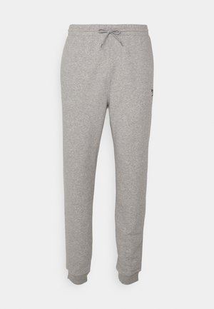 Gray sweatpants made of soft fabric, featuring a drawstring waist and tapered legs, with ribbed cuffs and a small logo detail on one side.