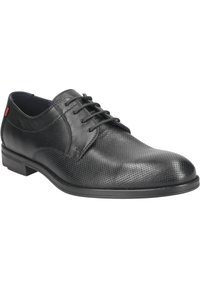 Černé kožené společenské boty s hladkým povrchem a perforovanými detaily. Disponují šněrovacím designem, kulatou špičkou a nízkým podpatkem.