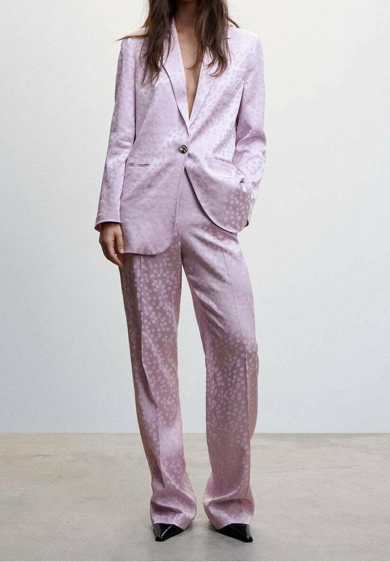 Lilac satin suit featuring a patterned texture, single button closure, and wide-leg trousers. Complete with pointed black heels.